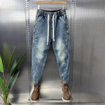 Mens Washed Denim Jeans With A Vintage Design, Featuring Button Detailing And A Tapered Leg